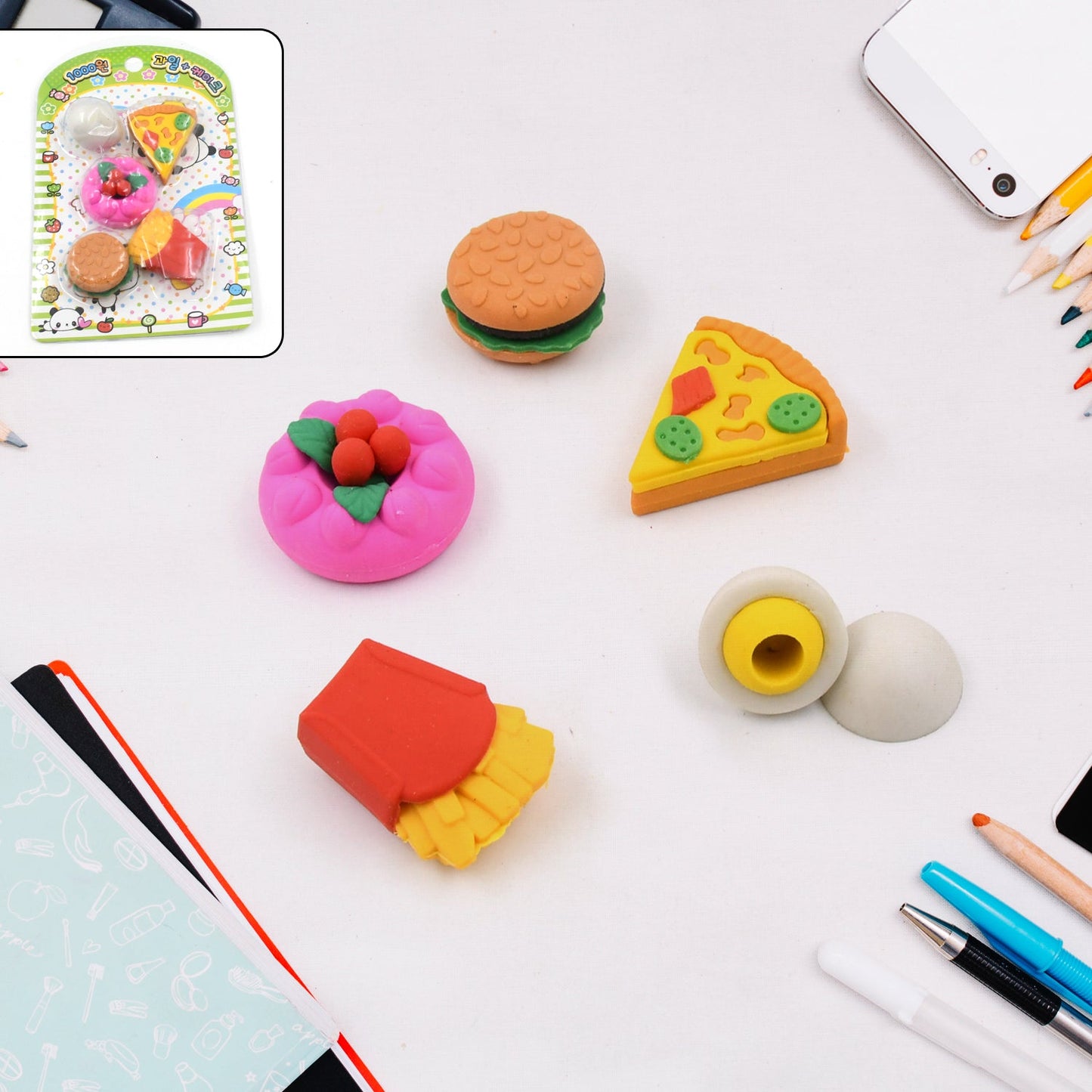 An assortment of colourful food-shaped erasers arranged neatly on a white background.