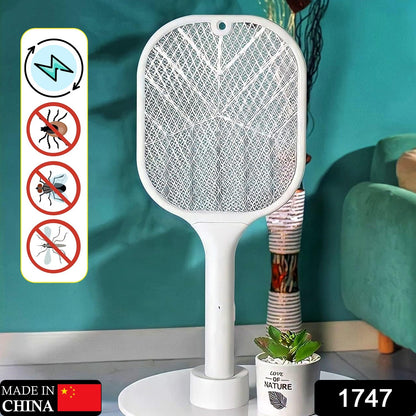 Hand holding the electric fly swatter, ready to zap insects.