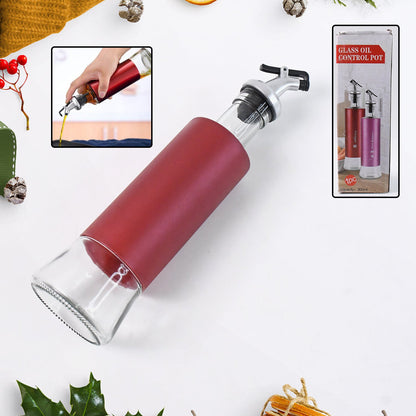 Close-up of glass oil dispenser showing durable plastic covering and golden spout