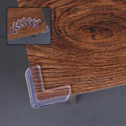 Close-up of a transparent silicone baby corner protector installed on a wooden table.