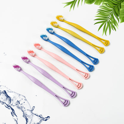 Close-up of the dual-action head of the toothbrush with soft bristles and integrated tongue scraper.