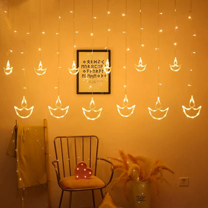 Close-up of warm white Diya Curtain String Lights illuminating a festive window.