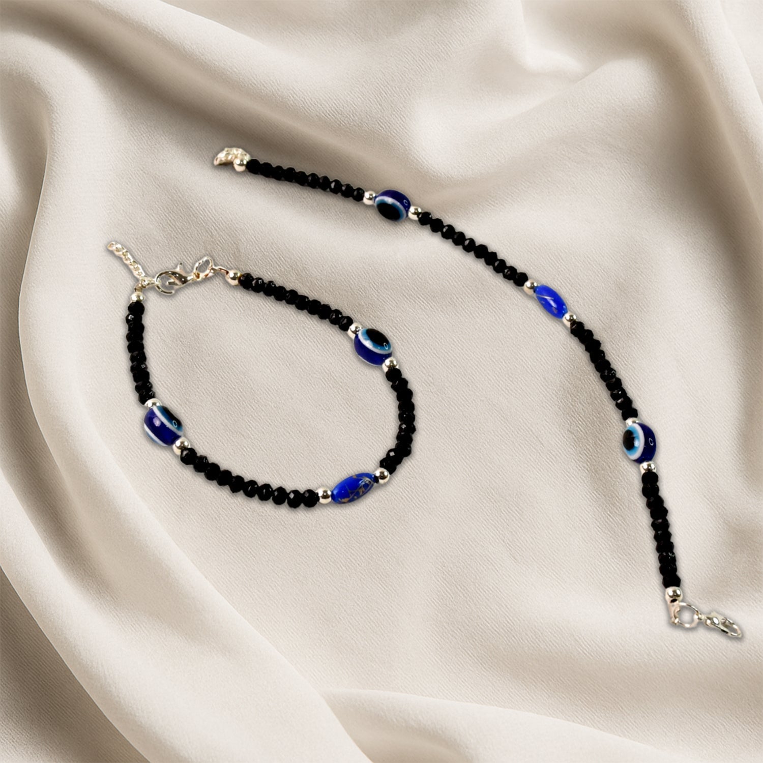 Close-up of adjustable black bead evil eye bracelet charms