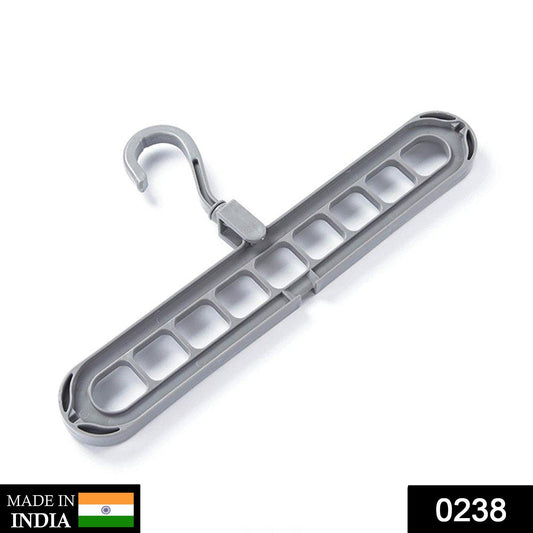 A white space saving hanger holds multiple garments neatly in a modern wardrobe.