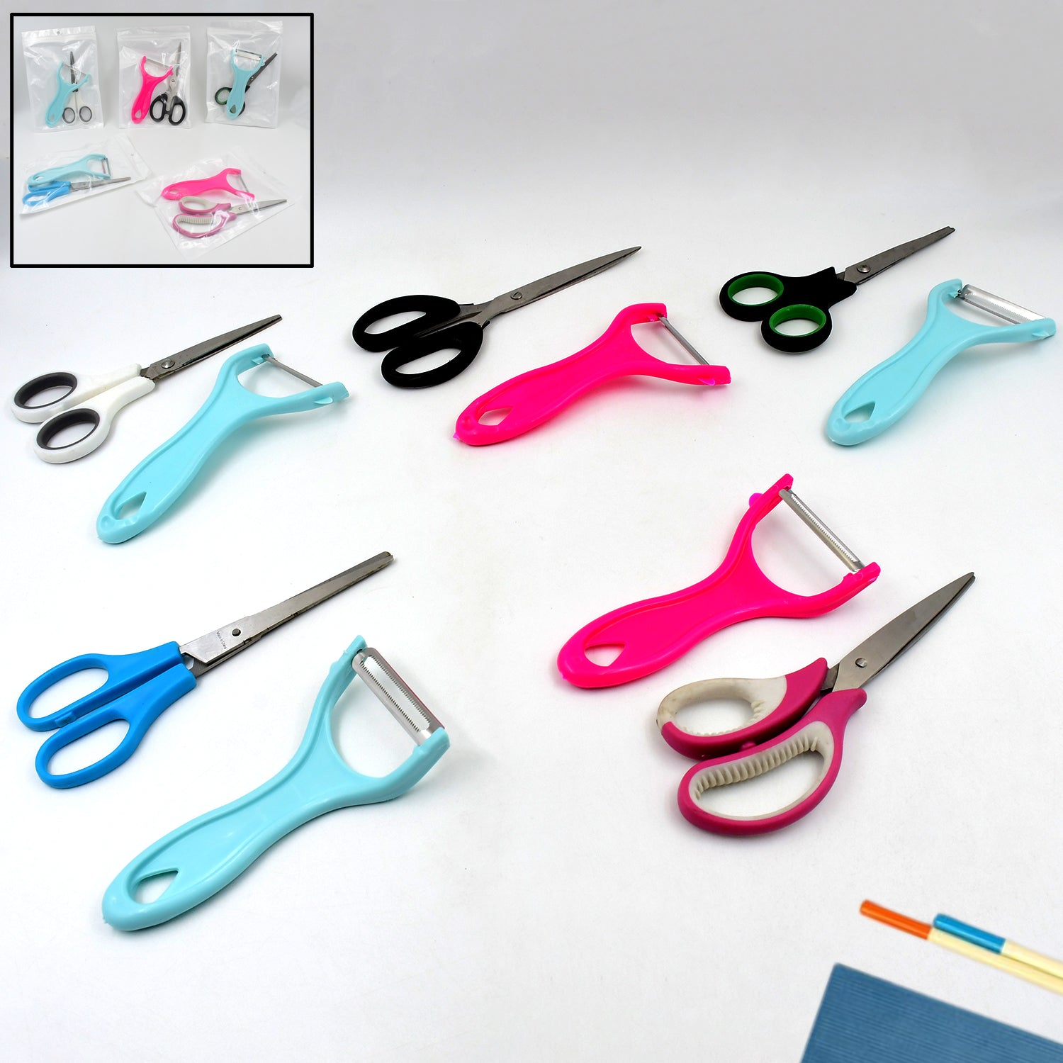 Stainless steel kitchen scissor and vegetable peeler set on a clean surface.