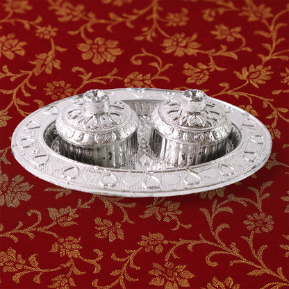 Oval kumkum holder on decorative puja thali