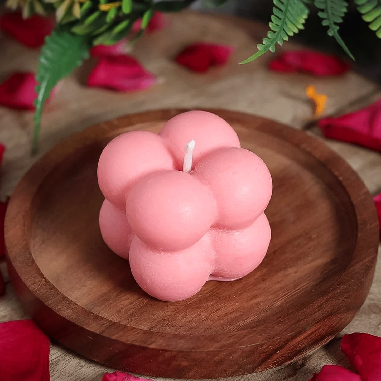 Close-up of flame-lit bubble cube candle casting warm, cozy glow at home