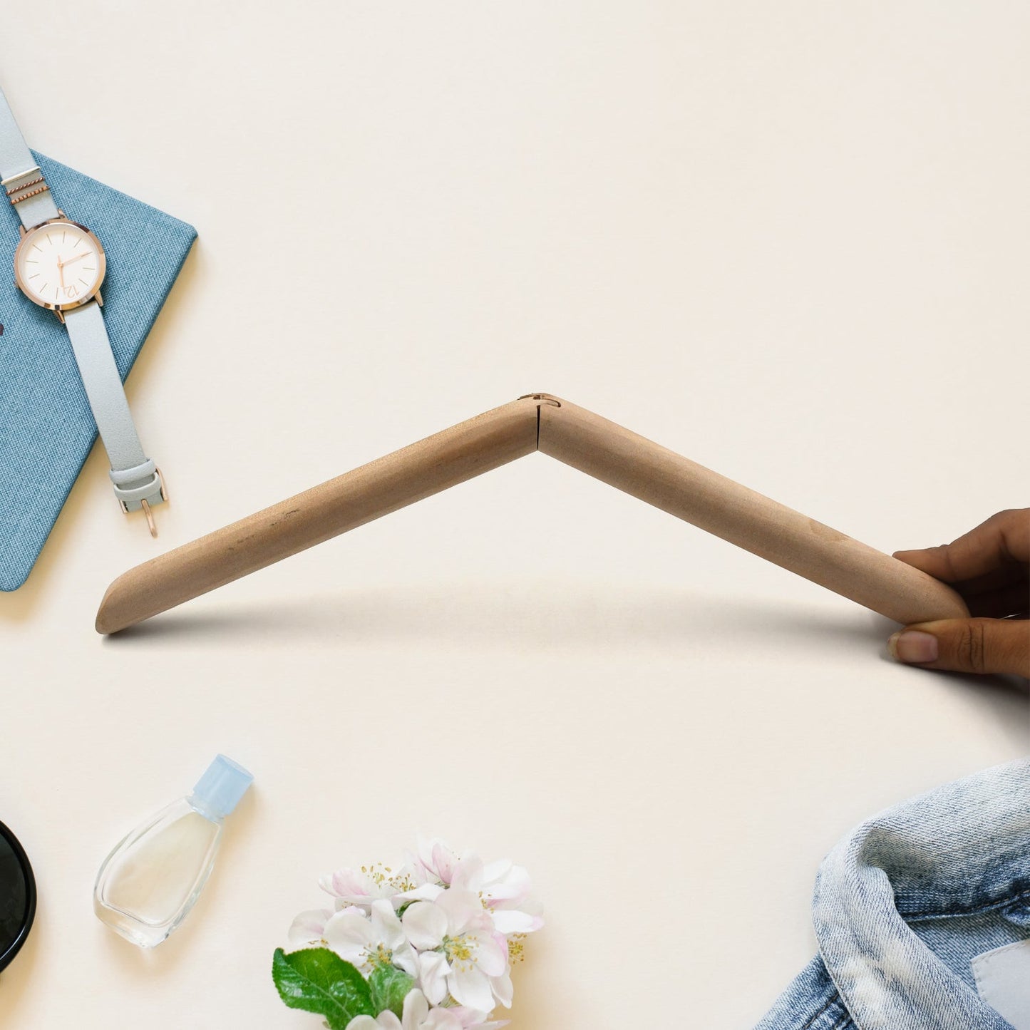 Front view of a sturdy wooden suit hanger against a light background.