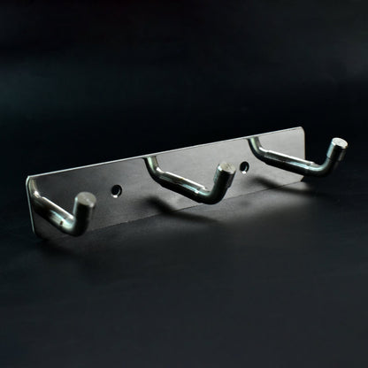 Polished metallic 3 hook rack mounted on bedroom wall