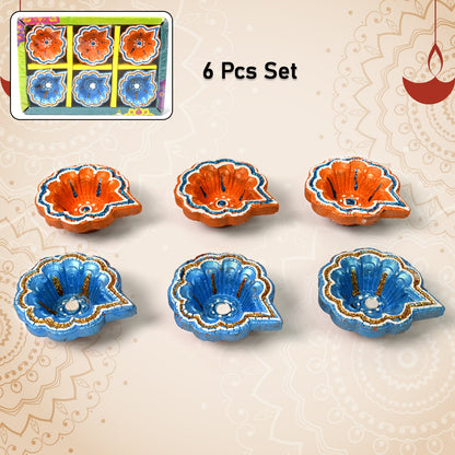 Intricate peacock design on a hand-painted clay diya, showcasing traditional Indian artistry.