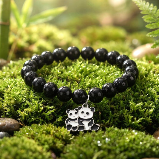 Pastel bead stretch bracelet with black butterfly charm displayed on wrist