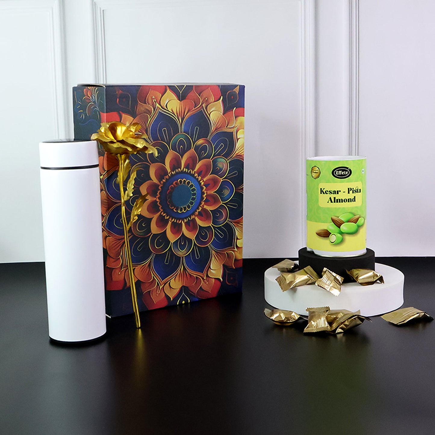 Stainless steel bottle included in festive kesar pista almonds gift set.