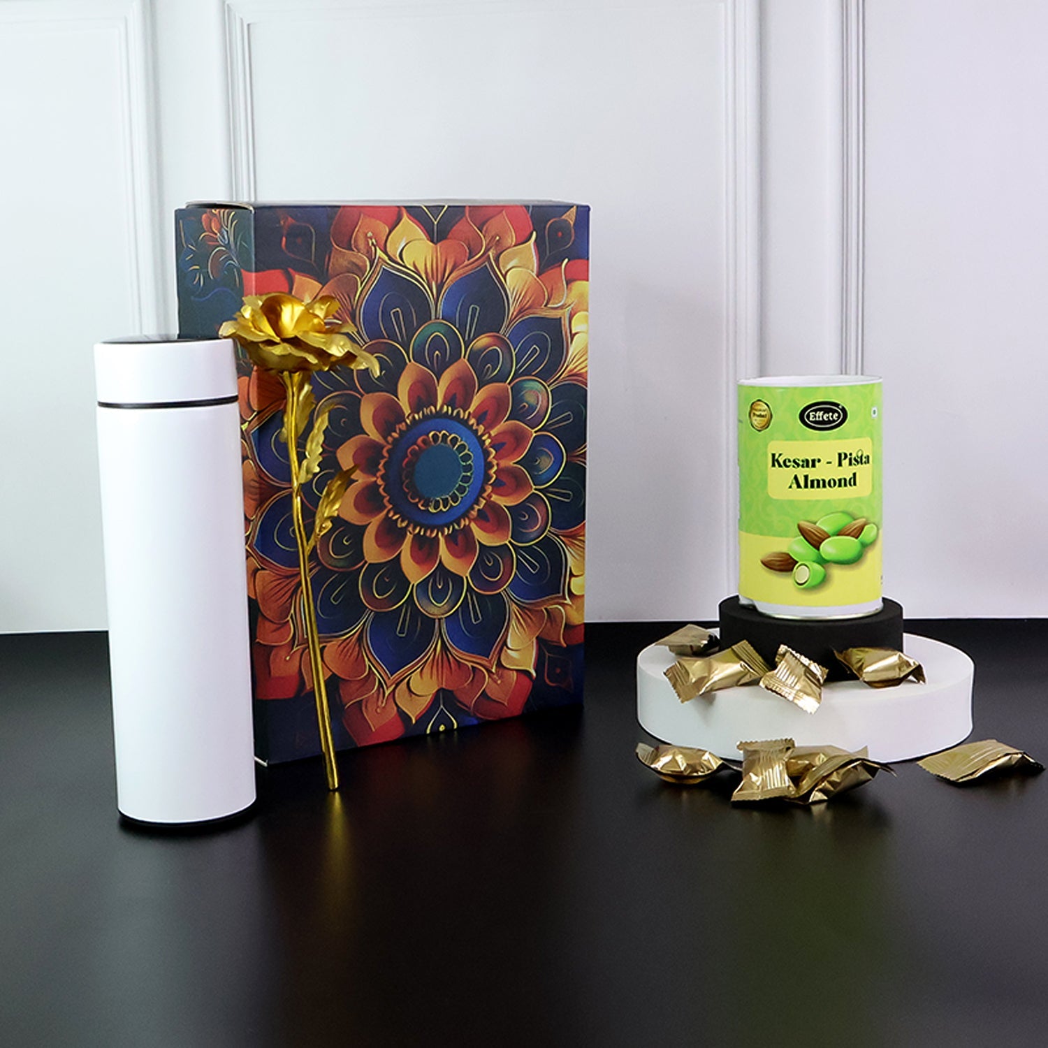 Stainless steel bottle included in festive kesar pista almonds gift set.