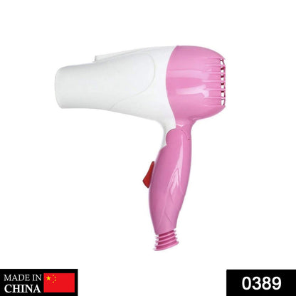 Compact foldable hair dryer with two speed control settings.