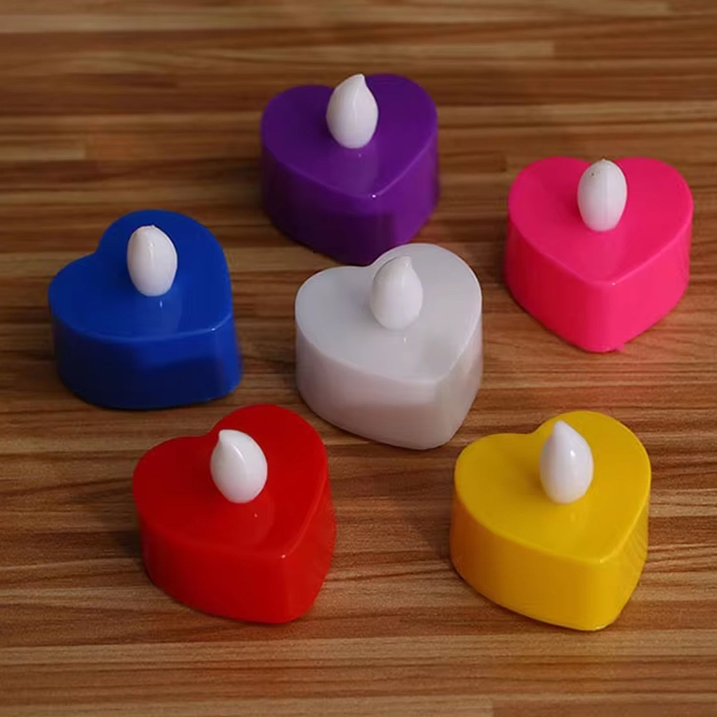 Close-up of a battery-operated LED tealight showing its flickering warm glow.