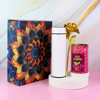 Close-up of almond chocolate diwali hamper with golden rose and stainless steel bottle