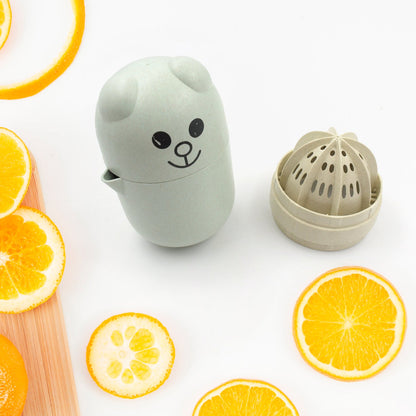 Hand squeezing an orange with the efficient manual citrus juicer.