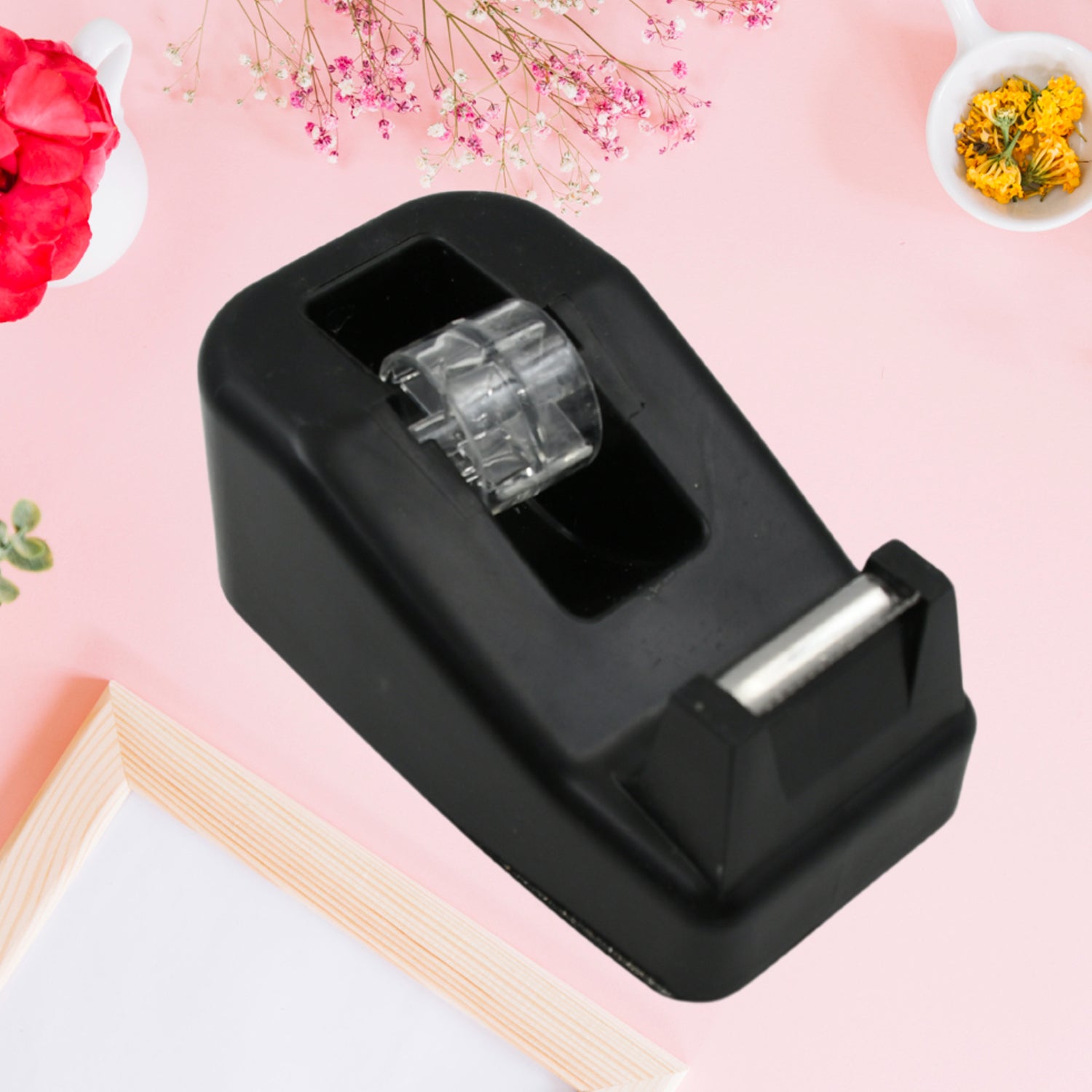 Angled view of the durable plastic construction of the VoltDesk tape dispenser, highlighting its comfortable grip.