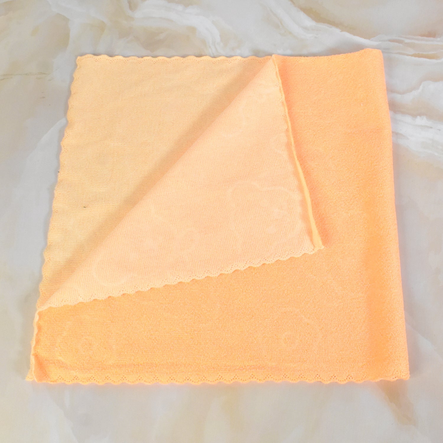 Set of three colorful kitchen hand towels, neatly folded.