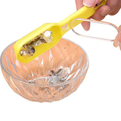 Hand holding the fish scale scraper, highlighting ease of use.