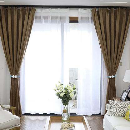 Magnetic curtain tieback twisted to adjust length on window curtain