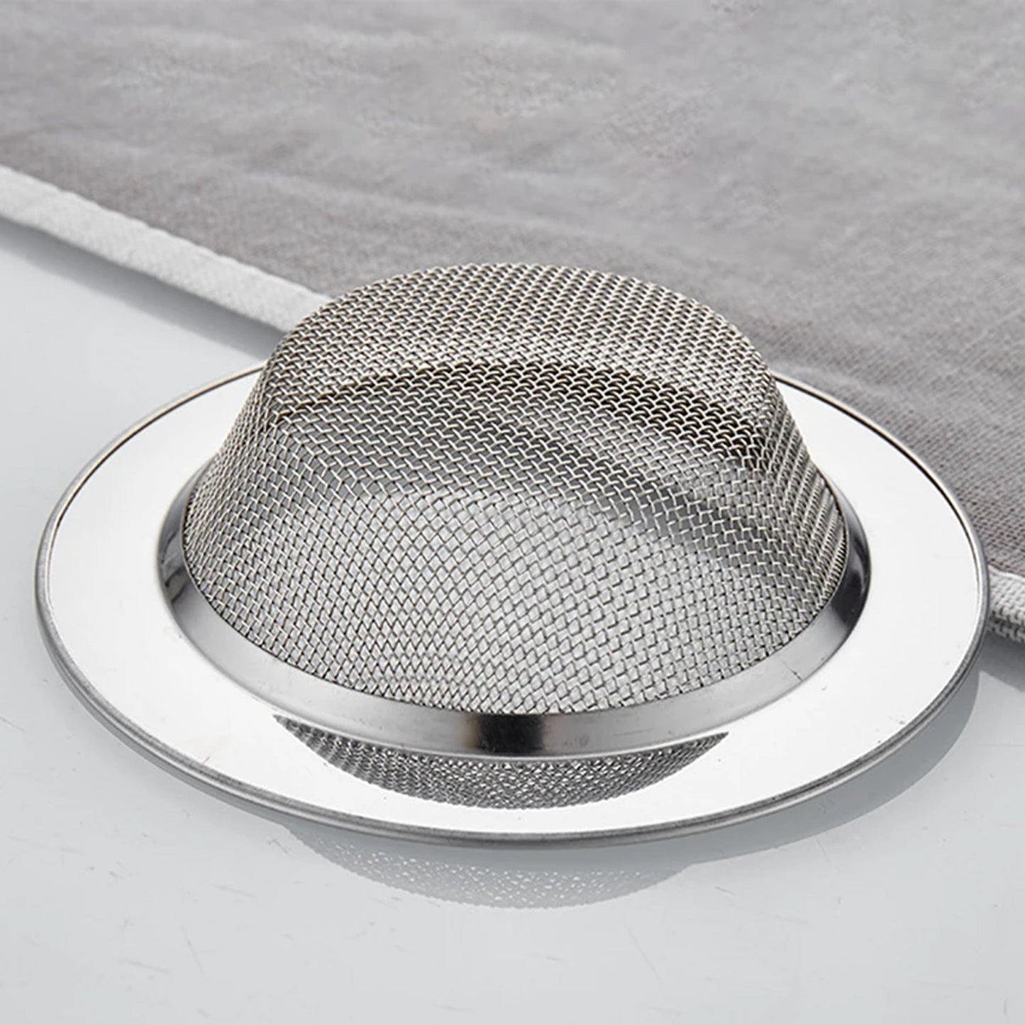 Side view of stainless steel dome-shaped drain hair catcher