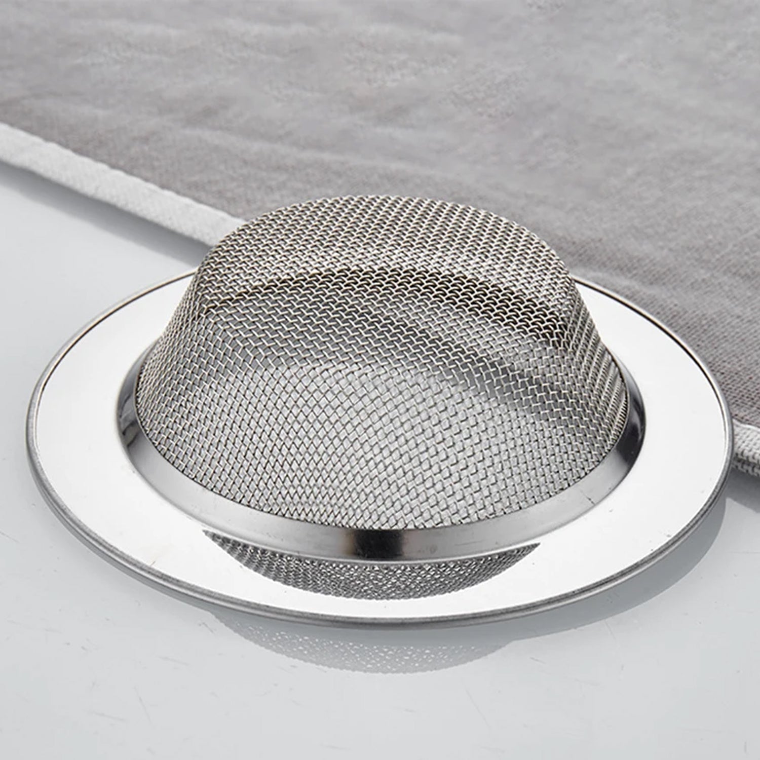 Side view of stainless steel dome-shaped drain hair catcher
