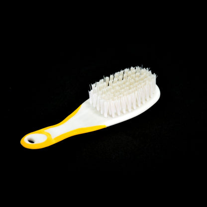 Person demonstrating how to hold the ergonomic Handle Grip Nail Brush for easy cleaning.