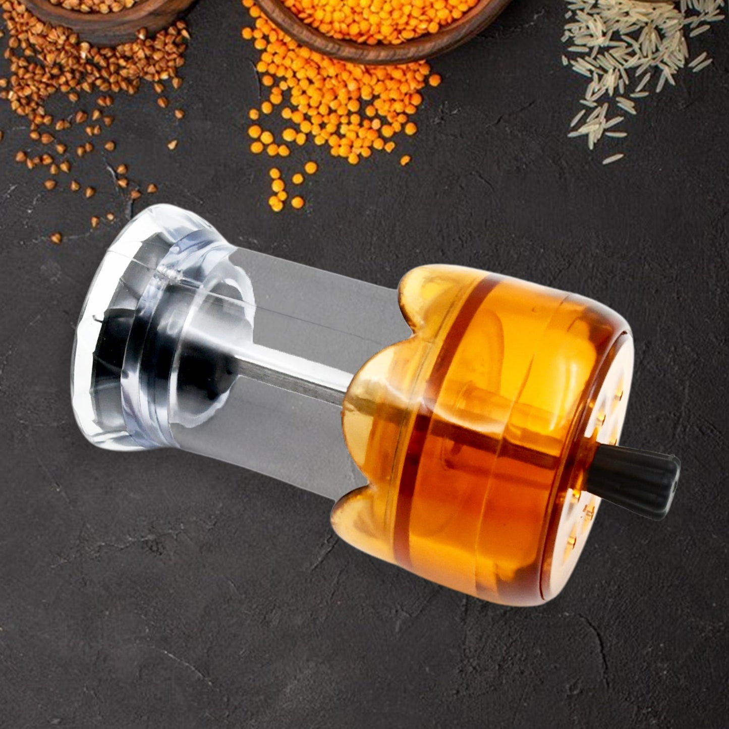Angled view of the transparent plastic salt and pepper grinder.