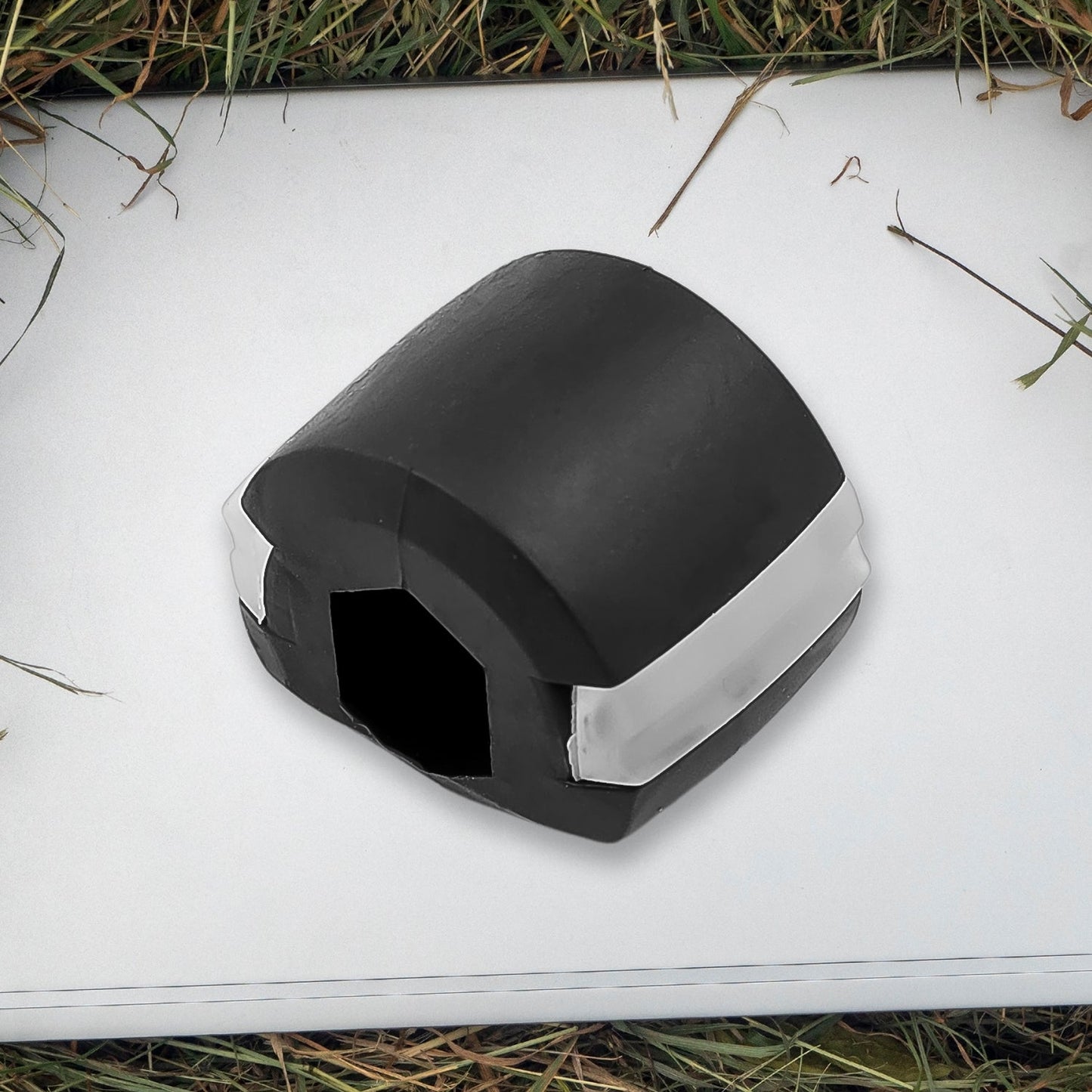 Side profile of the black Jaw Exerciser, showing its compact size.