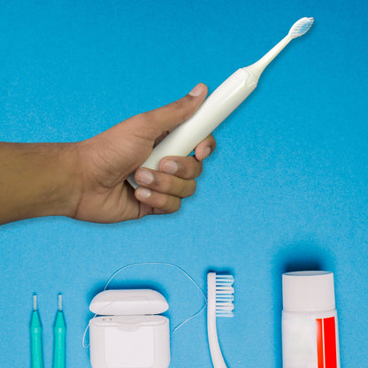 Components of the BrushedUp Electric Toothbrush, including the handle and a replacement brush head.
