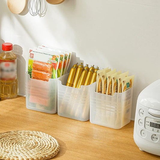 A set of three clear plastic drawer organizers shown neatly arranged in a drawer.