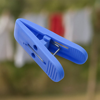Multicolor plastic cloth drying clips securely holding laundry on a clothesline.