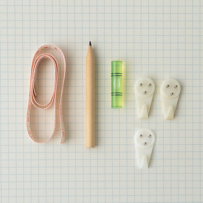 Close-up of wall hanging tools with measuring tape and bubble level