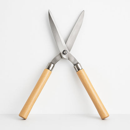 Angled view of the Indo Glow Hedge Shears, highlighting both the wooden handles and the sharp steel blades.
