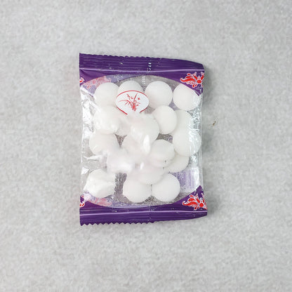 Close-up image of round naphthalene mothball tablets for wardrobe freshness
