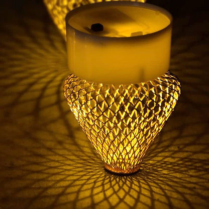Bottom view of a flameless LED candle showing the battery compartment and on/off switch.