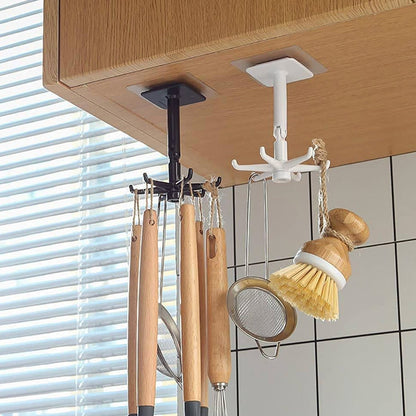 A hand demonstrating the 360-degree rotation of the self-adhesive wall hook.