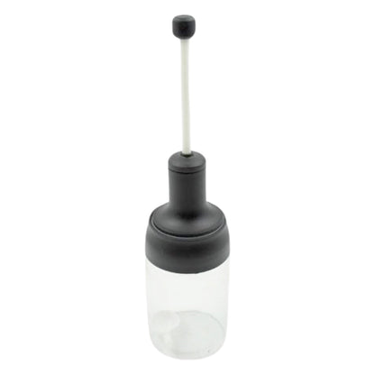 The sleek design of the Heat-Resistant Glass Seasoning Jar on a kitchen counter.