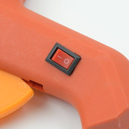 The 60-watt hot melt glue gun displayed with its included glue sticks, ready for various DIY tasks.