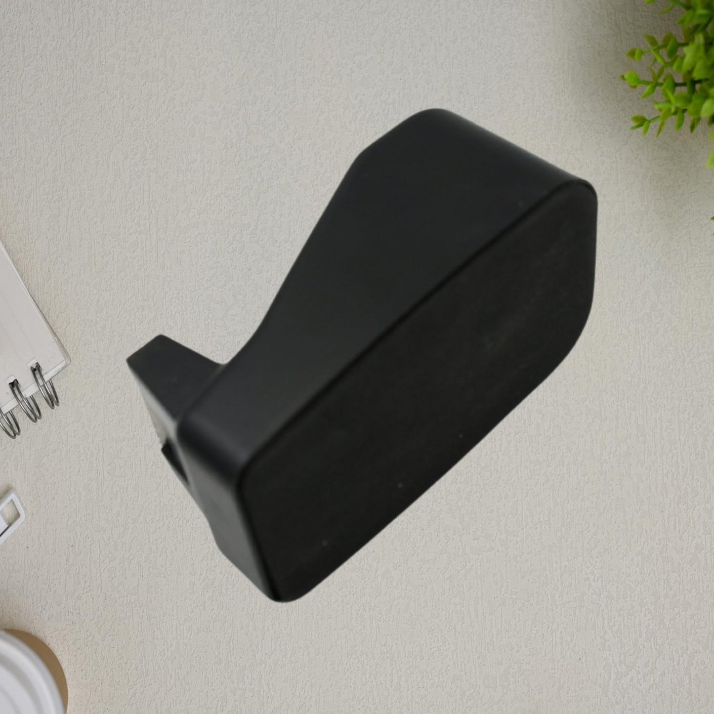Side profile of the VoltDesk handheld tape dispenser, illustrating its lightweight and compact form factor.