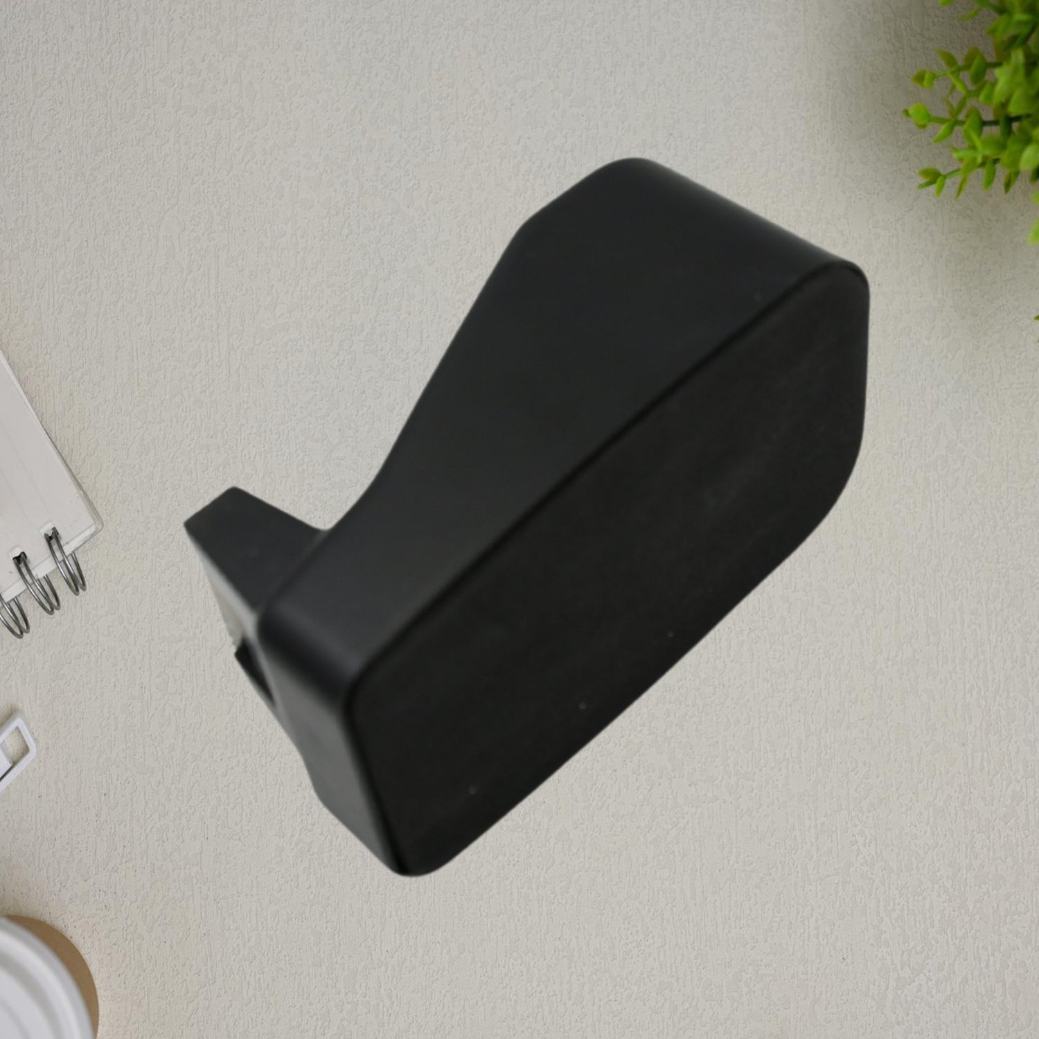 Side profile of the VoltDesk handheld tape dispenser, illustrating its lightweight and compact form factor.
