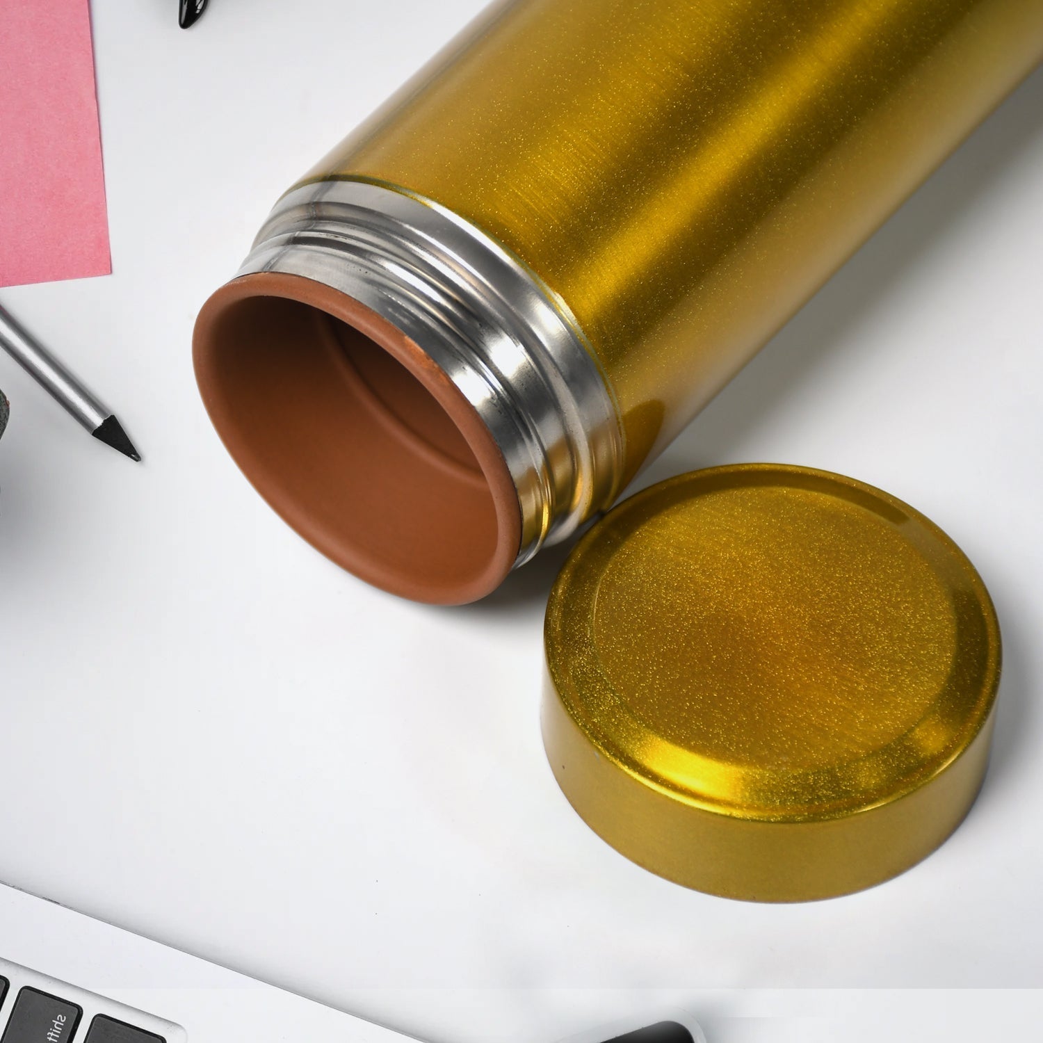 Stylish 300ml Vacuum Water Bottle for daily hydration, shown next to a book on a desk.