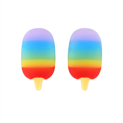 Child's hand holding a mini popsicle eraser, showing its compact size.