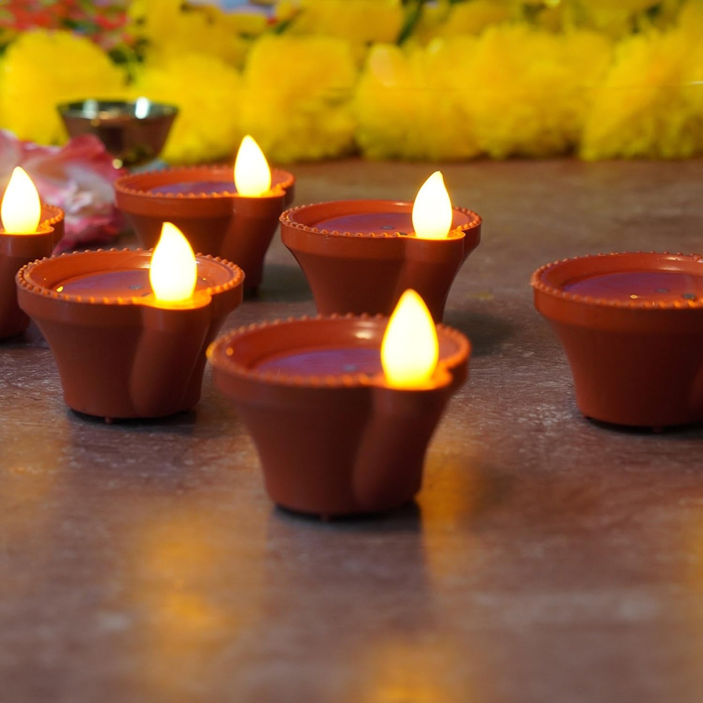 Multiple water sensor diyas scattered for a beautiful home decor.