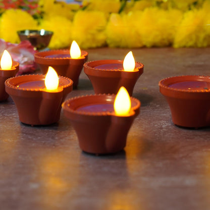Multiple water sensor diyas scattered for a beautiful home decor.