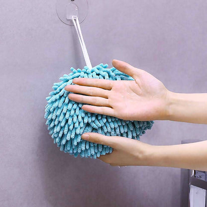 Hanging hand towel draped casually over a bathroom sink.
