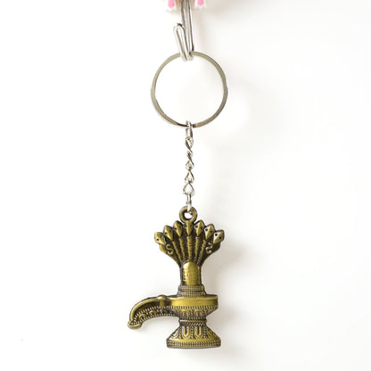 Close-up of Lord Shiva Shivaling metal keychain with detailed serpent design