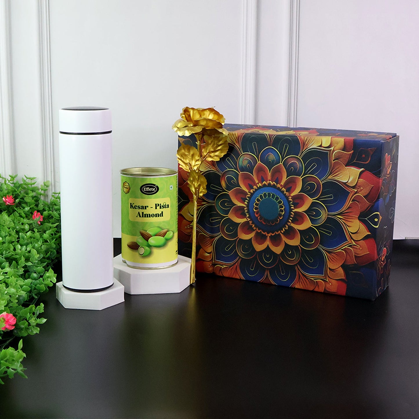 Premium kesar pista almonds gift combo with golden rose and bottle inside box.