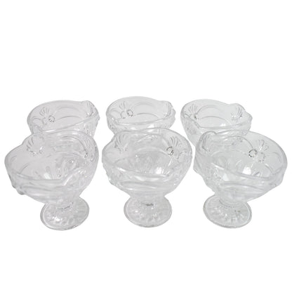 Variety of desserts like parfaits and sundaes beautifully presented in glass serving cups.